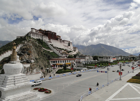 Tibet, China - Sep 6, 2010. Potala Palace with main road in Lhasa, Tibet Region. The palace was slightly damaged during the Tibetan uprising against the Chinese in 1959.