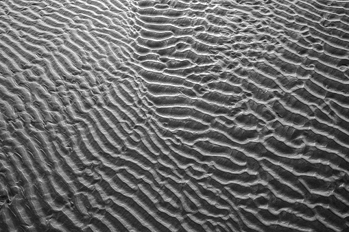 Abstract black and white photo of sand surface on a beach