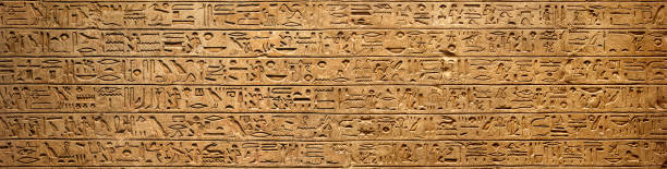istock Old Egyptian hieroglyphs on an ancient background. Wide historical background. Ancient Egyptian hieroglyphs as a symbol of the history of the Earth. 1614238269