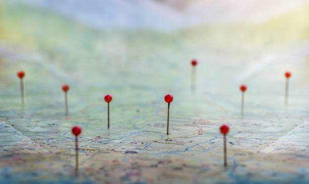 istock Location marking with a pin on routes on world map. Adventure, discovery, navigation, communication, logistics, geography, transport and travel theme concept background.. Macro photo. 1614245477
