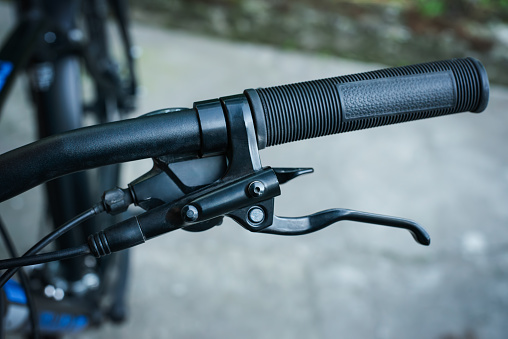 Handlebar of modern bicycle with brake handle and speed switch