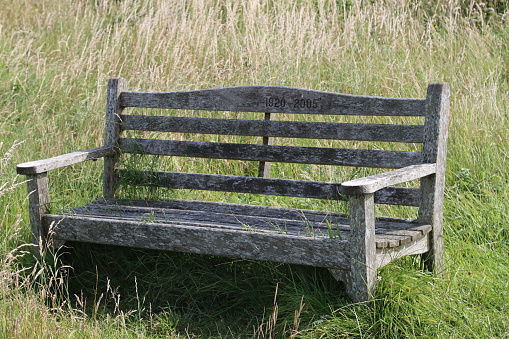 A park bench inscribed \