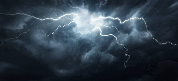istock Thunderous dark sky with black clouds and flashing lightning. Panoramic view. Concept on the theme of weather, natural disasters, storms, typhoons, tornadoes, thunderstorms, lightning, lightning. 1614257207