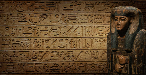 istock Sarcophagus with an Egyptian mummy on old Egyptian hieroglyphs. Ancient Egyptian hieroglyphs as a symbol of the history of the Earth. Ancient historical background. 1614257738