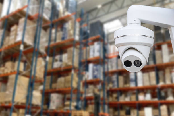 istock CCTV Camera Operating inside warehouse or factory. Copy space. 1614287371