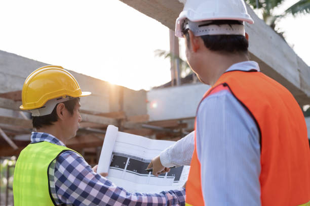 istock Engineers team use laptop and check the blueprint on site. Contractor and inspector inspection construction during project.civil Forman check quality assurance. Audit, inspect, quality control. 1614287940