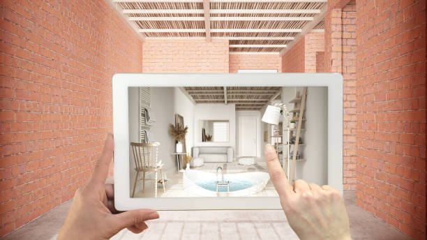 istock Augmented reality concept. Hand holding tablet with AR application used to simulate furniture and design products in interior construction site, wooden peaceful bathroom with bathtub 1614290286