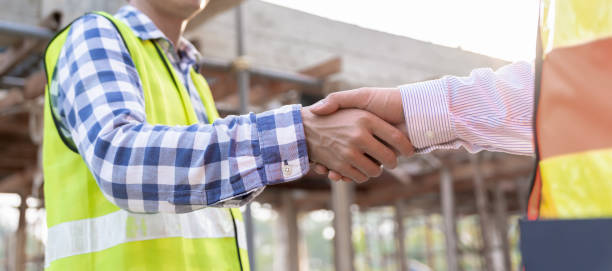 istock Construction worker team hands shaking greeting start up plan new project contract in office center at construction site, industry ,architecture, partner, teamwork, agreement, property, contacts. 1614299606