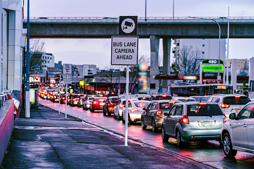 Cars in heavy congestion in the rush hour merging to avoid the bus lane are seen in Newmarket, Auckland on a day with strong winds and rains