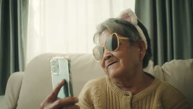Senior woman taking a selfie by smartphone.