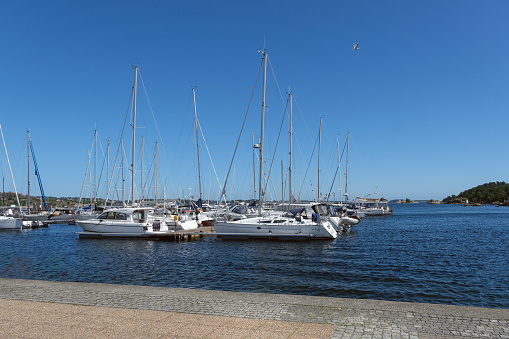 Idyllic moment at Kristiansand marina in southern Norway with blue skies and bright sunshine, copy space