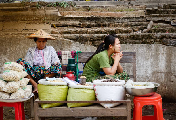 Mandalay, Myanmar - Feb 21, 2016. Vendors at a street market in Mandalay, Myanmar. Mandalay is the second-largest city and the last royal capital of Myanmar (Burma).