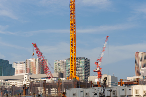 A building construction site and a forest of cranes and heavy machinery