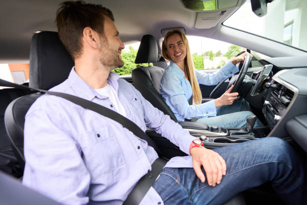 istock Happy married couple is located in a modern car 1614373776