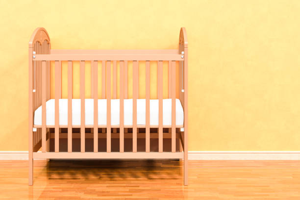 Baby crib, infant bed in room near wall, 3D rendering