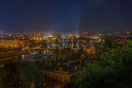 A scenic view of bridges over Vltava river in Prague, Czechia at night