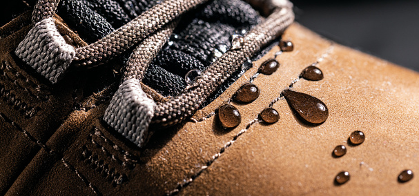 waterproof leather shoes. closeup of rain drops on water resistant footwear. weatherproof clothing