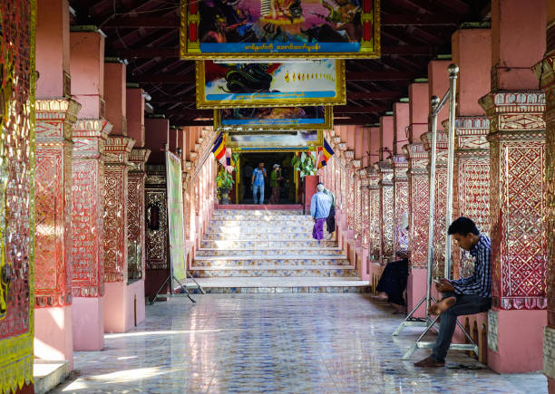 Mandalay, Myanmar - Feb 11, 2017. People at the lobby of ancient temple in Mandalay, Myanmar. Mandalay is the second-largest city and the last royal capital of Burma.