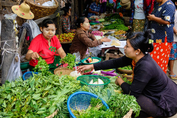 Mandalay, Myanmar - Feb 23, 2016. Vendors selling vegetables at local market in Mandalay, Myanmar. Mandalay is the second largest city in Burma, and a former capital of Myanmar.