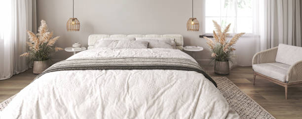 istock Light home interior wall mock up with white bed and dry plant in coastal bedroom. Empty picture frame mockup. Free space on front. 3d rendering. High quality 3d illustration 1614411756