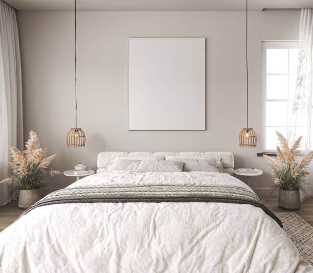 istock Light home interior wall mock up with white bed and dry plant in coastal bedroom. Empty picture frame mockup. Free space on front. 3d rendering. High quality 3d illustration 1614411761