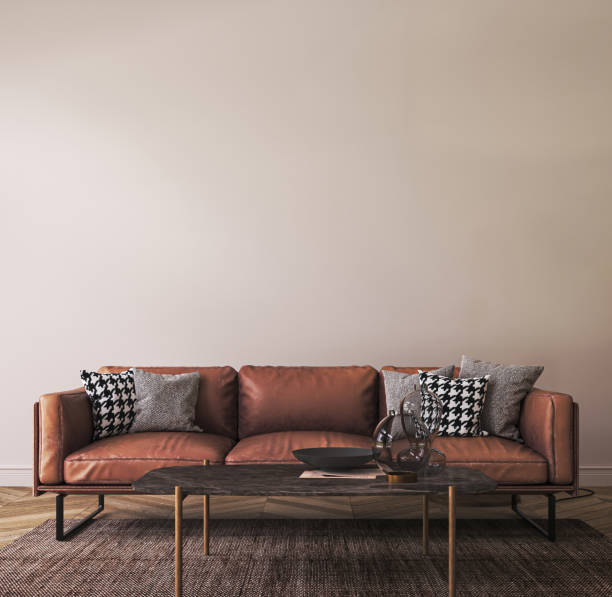 istock Light living room interior in loft with leather sofa, large lamp and decor. White wall mockup background. 3d render. High quality 3d illustration 1614412890