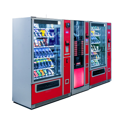 Side view of group of red free standing snack and coffee vending machines with contactless payment terminal isolated on white background. Glare is reflected on black screen. Small business theme.