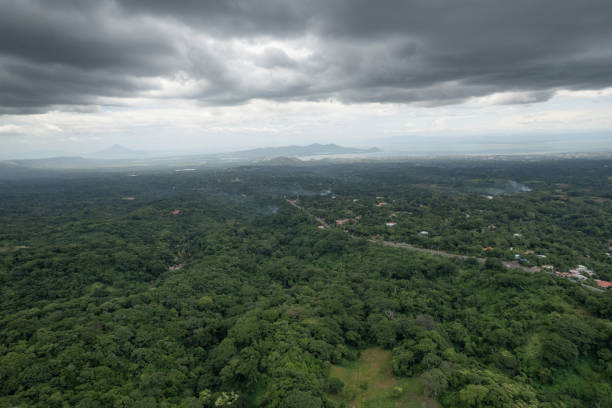 istock Green valley landscape with lake and volcano 1614445809