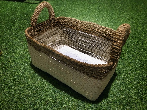 A rectangular wicker basket is made from banana fiber skin as a craft