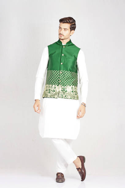 istock Man posing in white kurta pajama with green waistcoat 1614459967