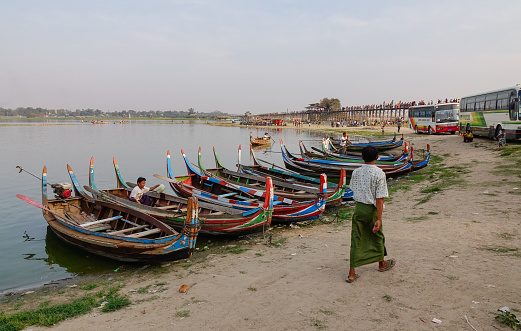 Mandalay, Myanmar - Feb 20, 2016. Wooden boats waiting on Taungthaman Lake near U Bein Bridge in Amarapura, Mandalay, Myanmar (Burma).