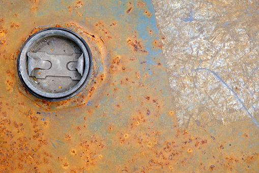 galvanized steel oil tank that weathered corrosion, abstract energy industry background, close-up top view with copy space