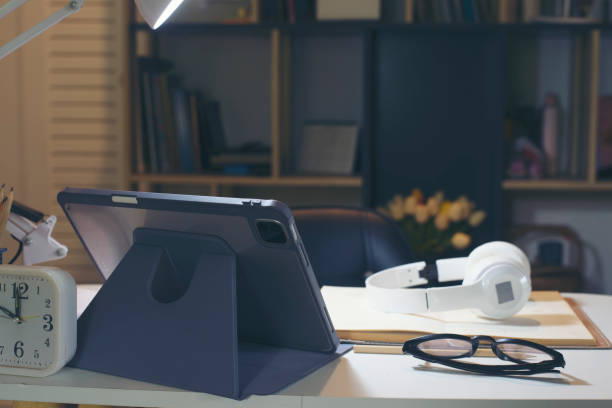 istock Business executive home office Desk Background concept. Business empty home office table with Digital tablet, Book, clock, glasses, headphone, notebook, diary book, document, and paper. 1614484983