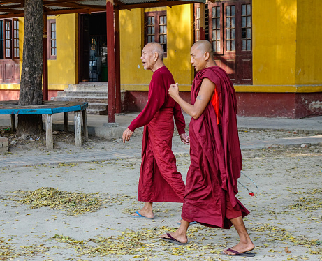 Bagan, Myanmar - Feb 21, 2016. Monks walking at the Buddhist temple in Bagan, Myanmar. Bagan in central Burma is one of the world greatest archeological sites.