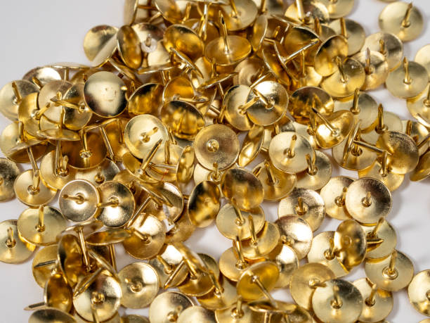 istock Pushpins of gold color on a white background. 1614494856