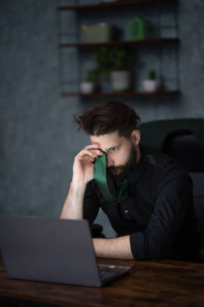 istock a young businessman works late in the office 1614510347