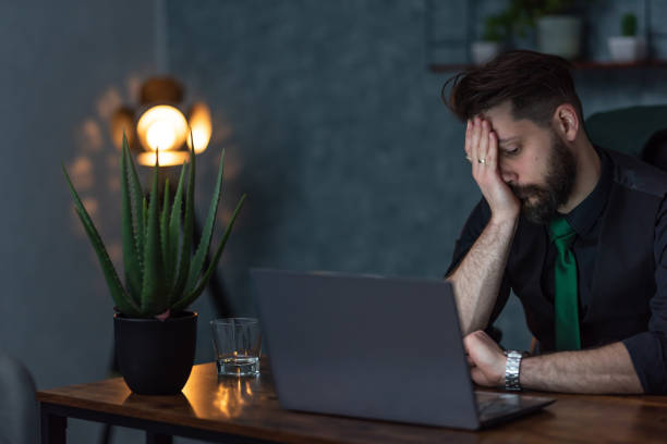 istock a young businessman works late in the office 1614510862