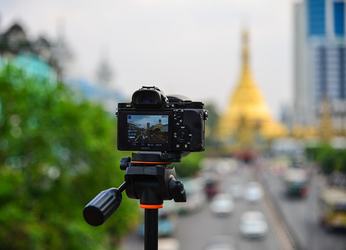 Yangon, Myanmar - Feb 1, 2017. A camera with tripod in Yangon, Myanmar. Yangon is the country main centre for trade industry and tourism.