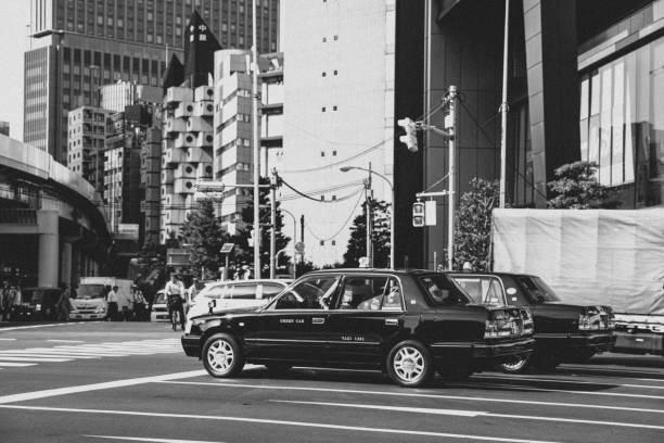 August 9, 2019: Black and white photo in the Shimbashi district in Tokyo, in the background the Nakagin building