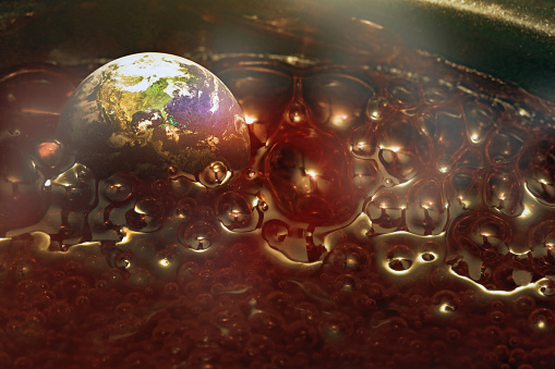 Hot world boiling in ominous bubbling fluid, symbolizing the climate crisis and the new term 