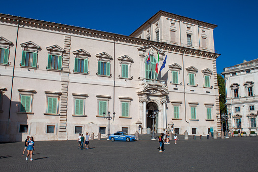Rome, Italy - August 06, 2023: Photo of the Quirinal Palace from the square of the same name on a sunny day, there are people and an Italian police car.