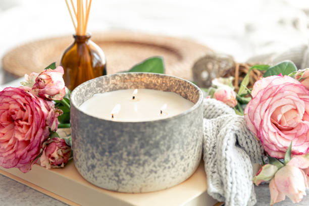 istock Spa composition with aroma oil diffuser lamp, flowers and candle. 1614547278