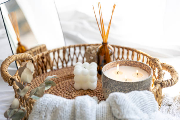 istock Spa composition with candles and aroma sticks in a wicker basket. 1614547296