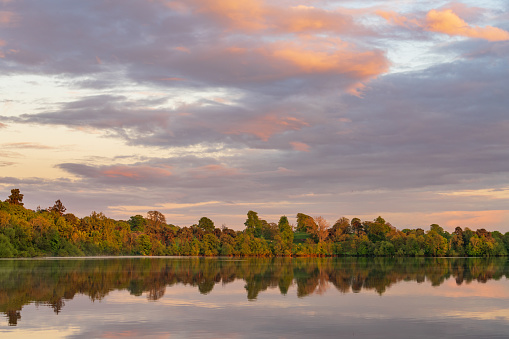 Sunset panorama of the lake shore of the Mere with a perfect lake reflection in Ellesmere in Shropshire