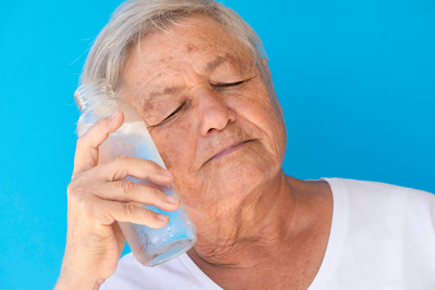 istock Old Woman Cools Down With Cold Water 1614612616