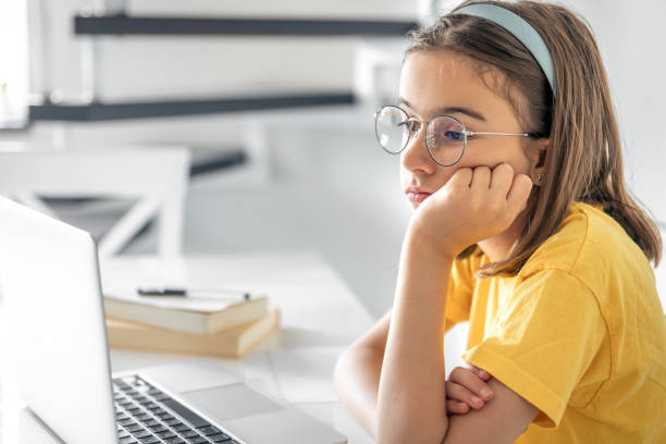 istock Exhausted schooler girl suffering from doing homework, tired from studying. 1614625943