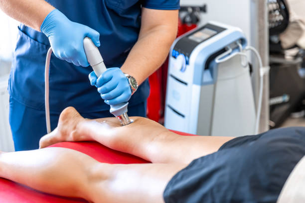 istock Physical therapy of the shin with shock wave, extracorporeal shockwave therapy. 1614645138