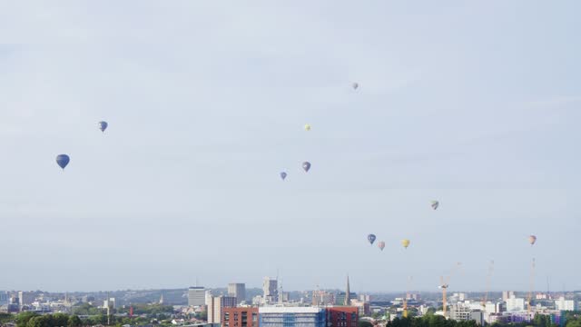 Dozens of hot air balloons flying over Bristol city