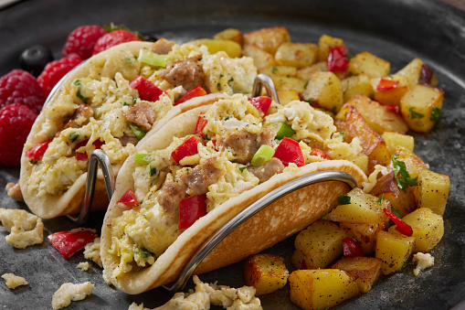 The Viral Pancake Breakfast Taco with Scrambled Eggs, Sausage, Red Peppers, Hash browns and Fresh Fruit