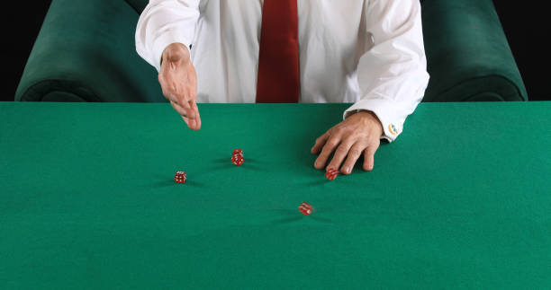 istock hands of a poker player on a green card table 1614665247
